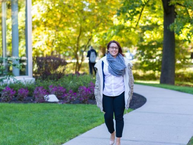 Graduate student walks along Cougar Walk