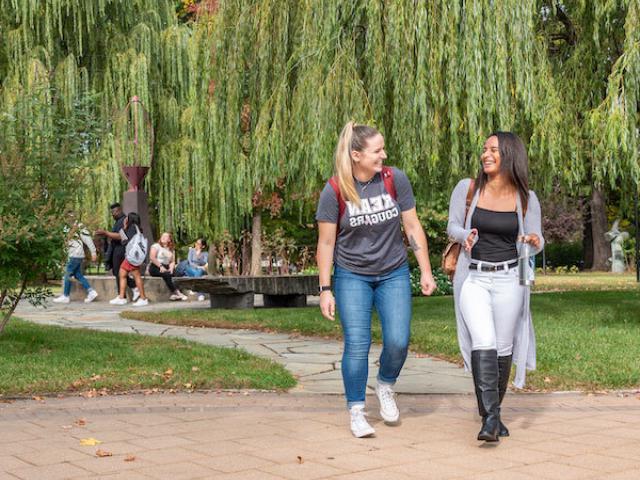 Two students walking outdoors on the Kean campus