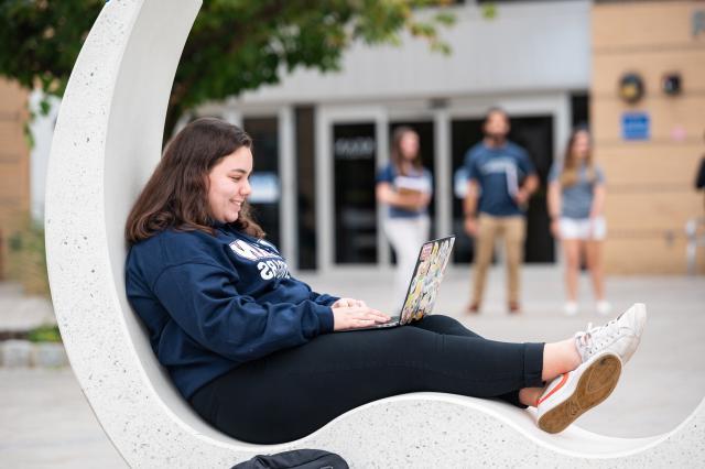 Kean student relaxes on the MSC patio