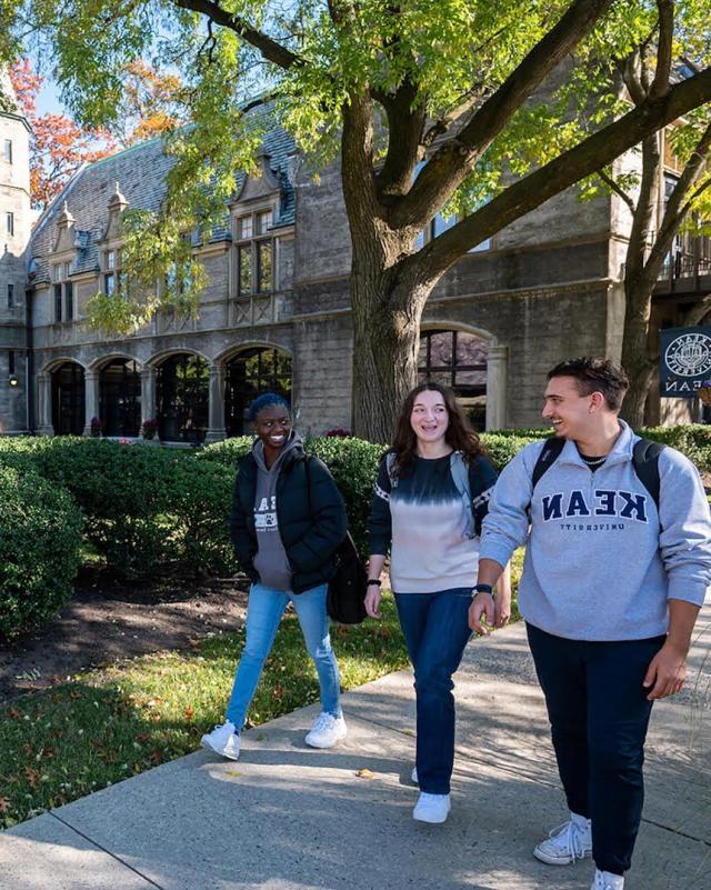 Three students walking together on Kean campus
